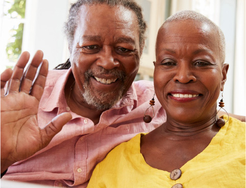 Senior couple waving on a virtual call